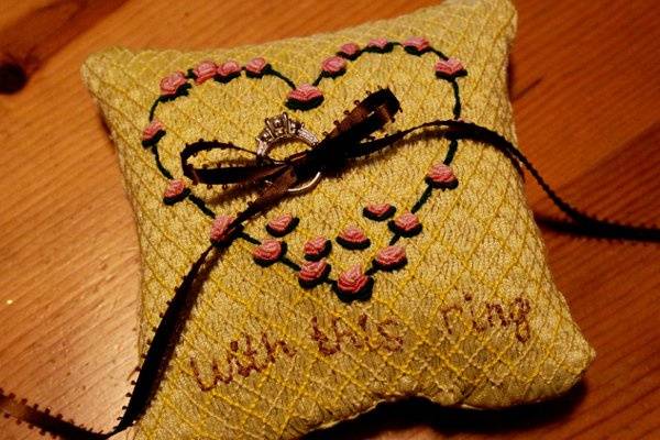 My ring bearer pillow. I smocked it and then embroidered bullion roses to form a heart. Then I embroidered 