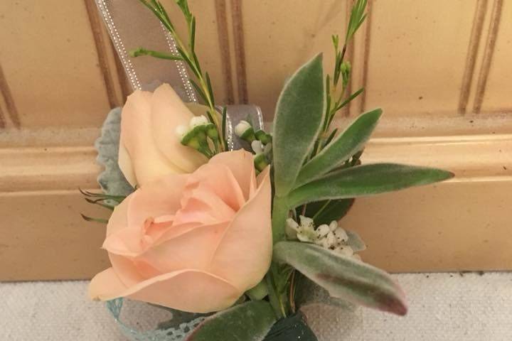 Simple rose boutonniere with added succulent accents
