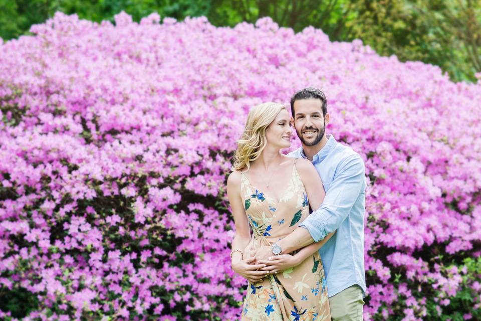 Couple posing beside wildflowers