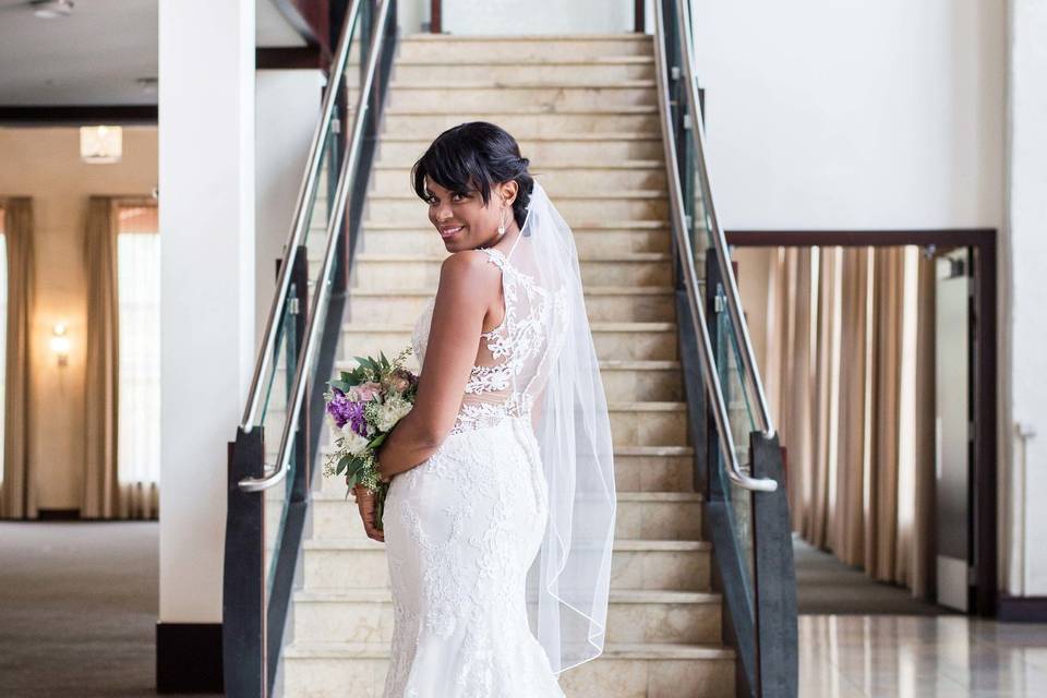 Bride posing by the stairs