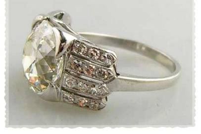 Very fine Art Deco platinum diamond ring centrally set with a old mine cut diamond weighing 4.01cts (VVS-K/L) flanked with four rows of 24 round cut diamonds totaling .60cts in a platinum mounting weighing 4.2dwt. Ring size 6 1/2.