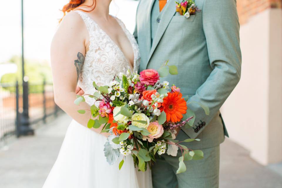 Couple holding colorful bouquet
