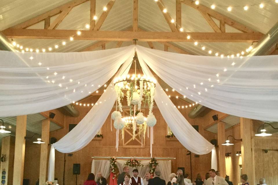 Drapes, hanging orchids and bistro lighting