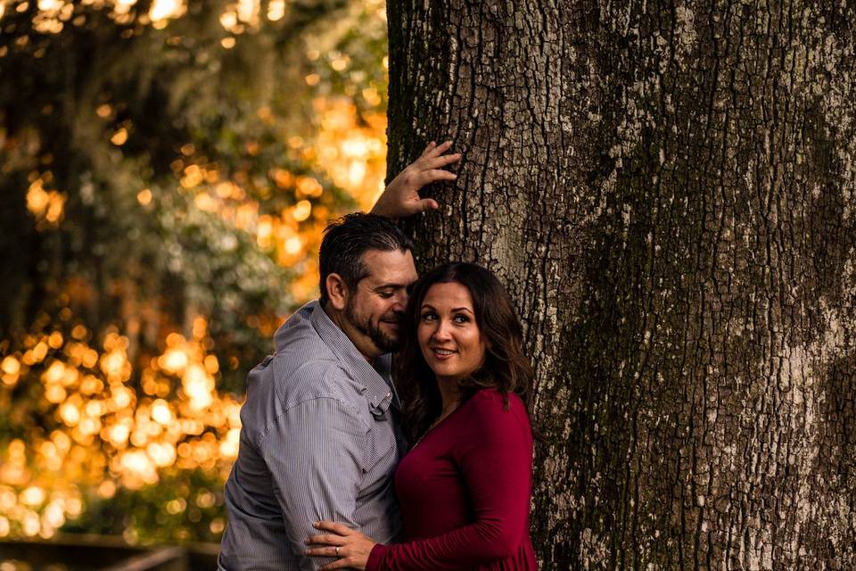 Couple leaning on tree