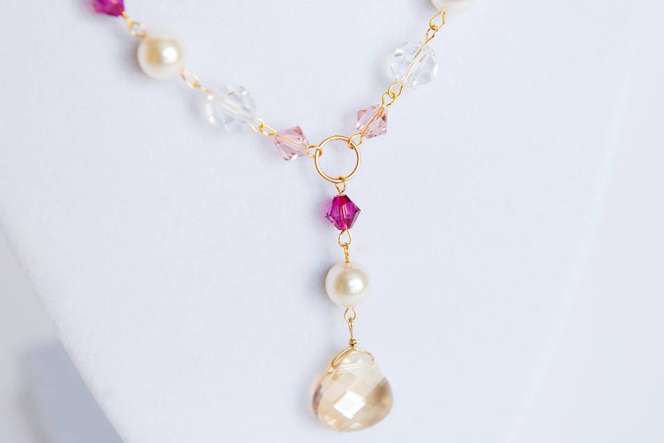 Handcrafted bridal necklace of Swarovski pearls and crystals in ivory, champagne, and fuchsia with teardrop crystal focal bead. Standard necklace length of 16