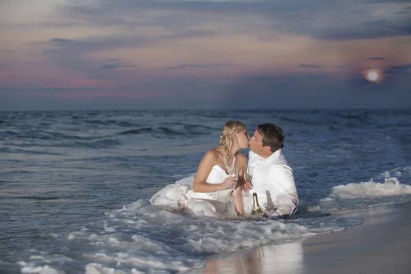 Mr. and Mrs. Chimarys on the beach on their location wedding.