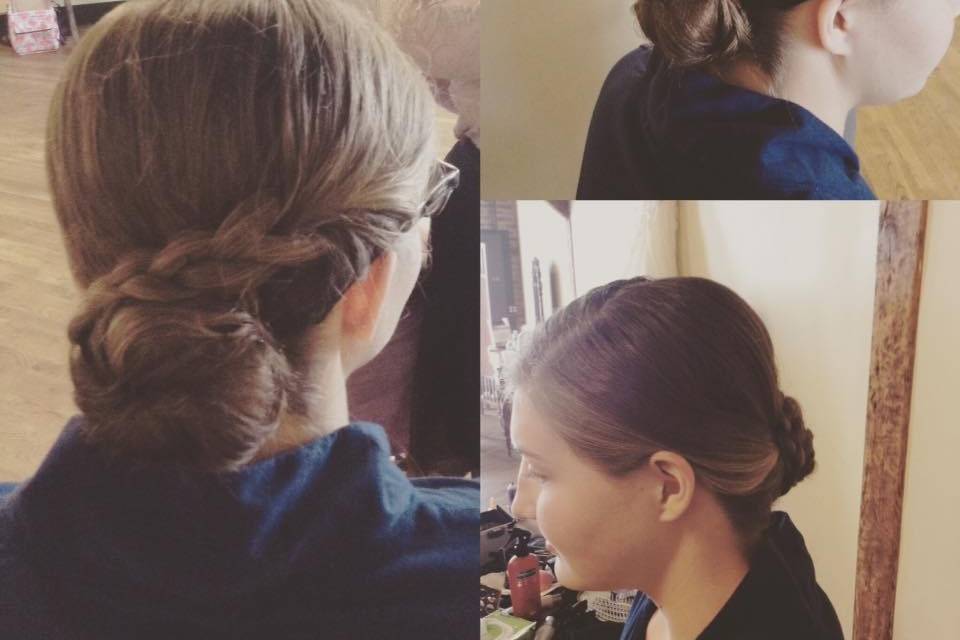The maid of honor - hair was swept into a bun, with a loose braid wrapped around from the right side.