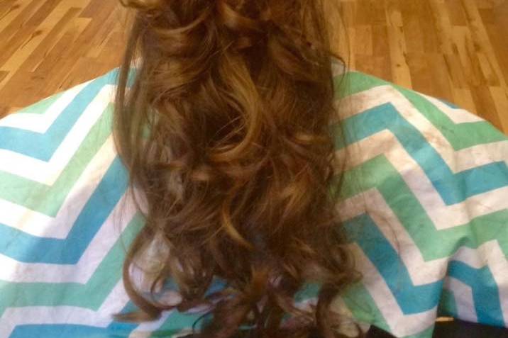 A shot of the back of the bride's hair. - hair was curled, teased at the crown, then swept into a half up-do