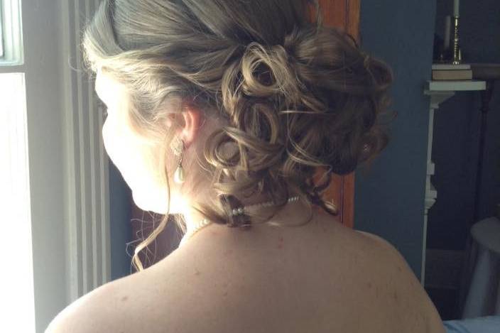 The bride - curled hair, teased at the crown, then pinned curls up to create a beautiful loose bun effect