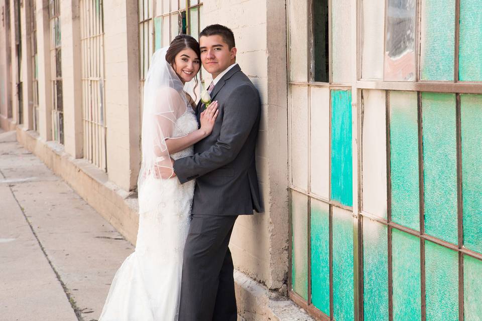 Couple posing beside facade