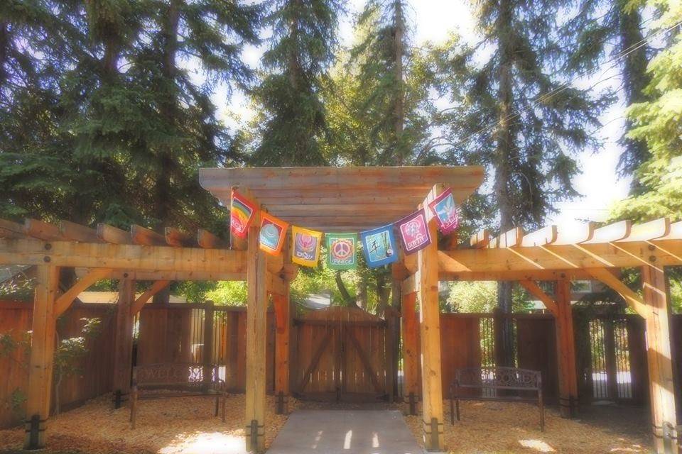 Backyard pergola with rainbow flags at UCC of Missoula, Missoula MT