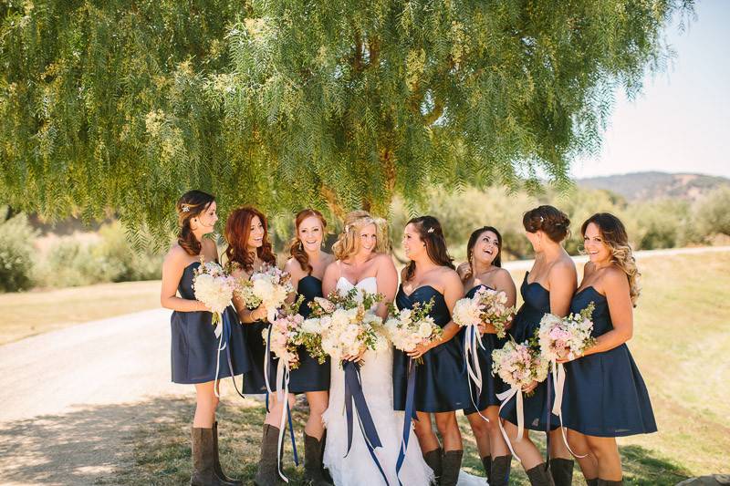 Bride and bridesmaids by the tree
