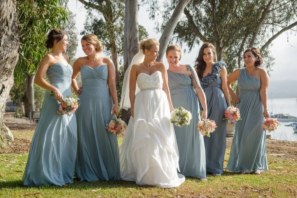 Bride and her bridesmaids by the water