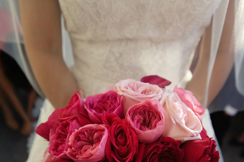 The perfect bridal bouquet with and array of garden roses in shade from hot pinks to blush pinks.