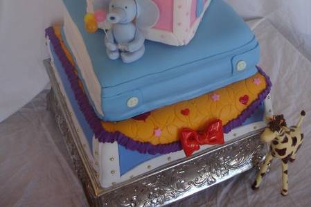 A 4 tiered fondant cake with edible sugar animals.