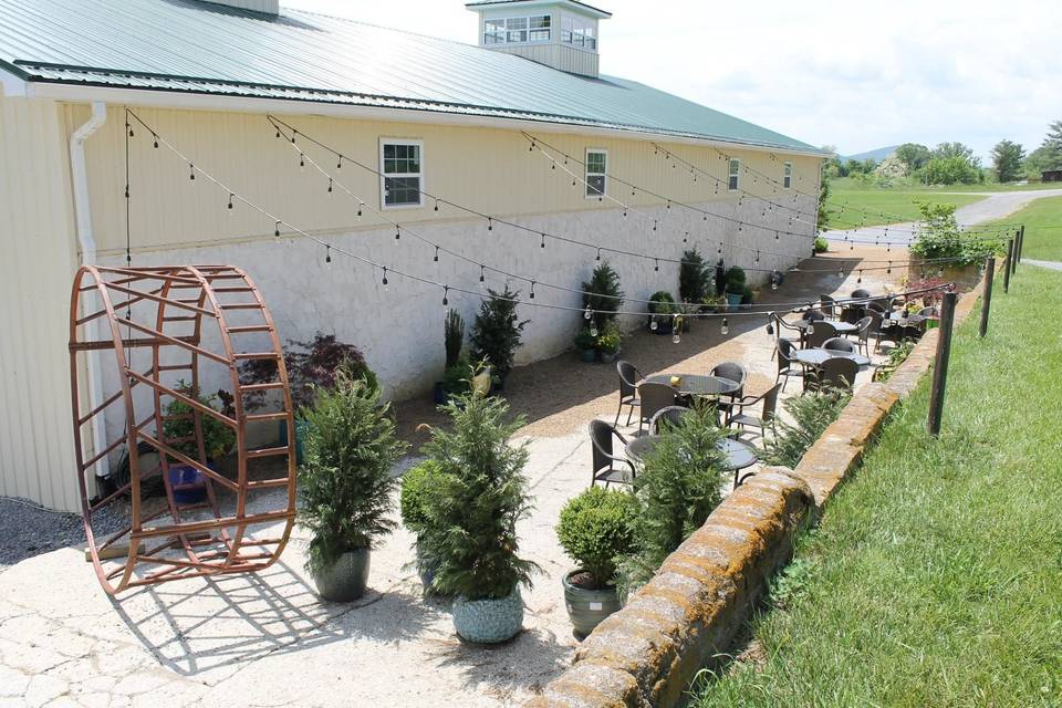 Outdoor seating surrounded by potted plantlife