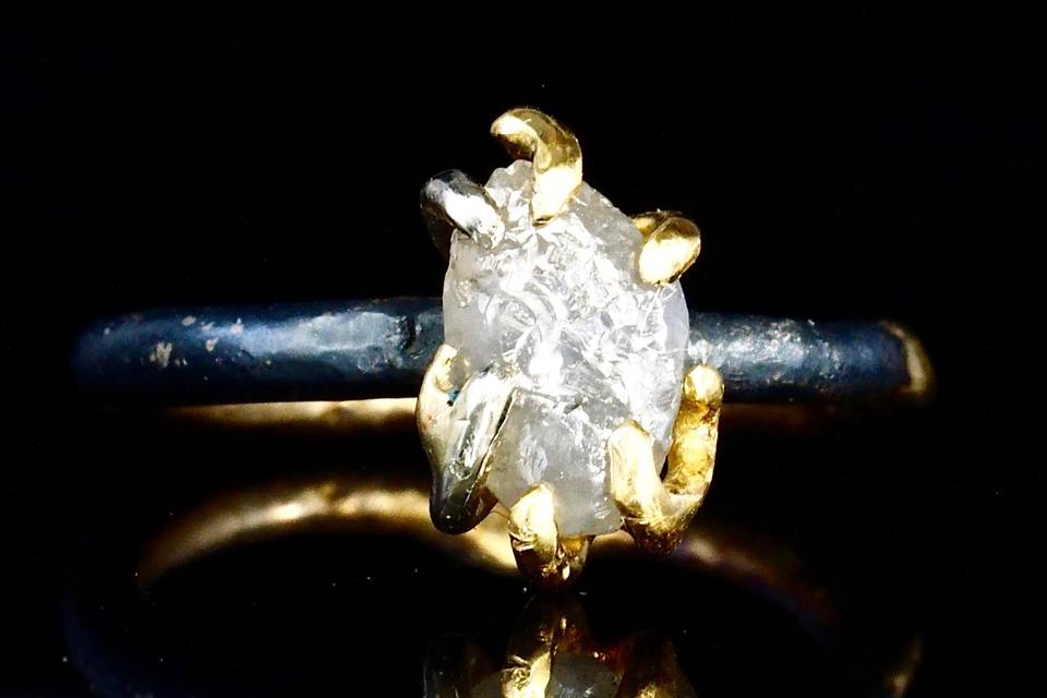 raw uncut white diamond mounted in 18k gold claws on oxidized silver and fused 18k gold band
