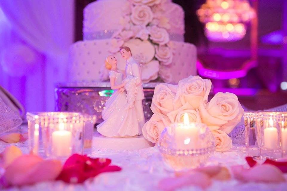 Dazzling candle centerpiece with white satin bow. White rosette satin tablecloth. The perfect combination to a dream wedding. #alexandriaweddingdecor #linens #decor #weddingdecor #wedding #centerpieces #favors