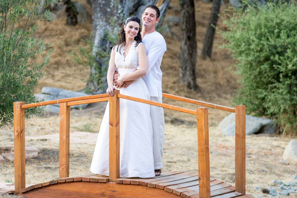 Newlyweds on a tiny bridge