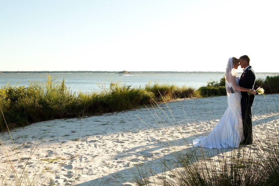 Beautiful private moment caught by our photographer.  The Charleston Harbor as the backdrop was amazing for this couple's wedding day.