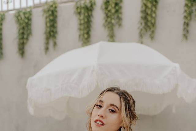 Bride poses wiith parasol