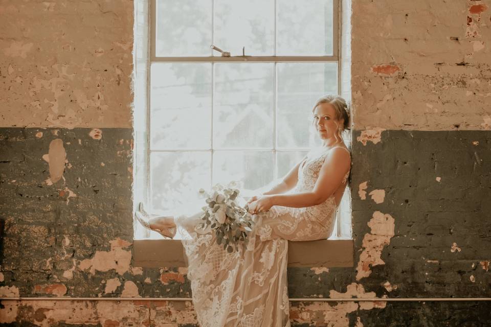 Bride seated by the window