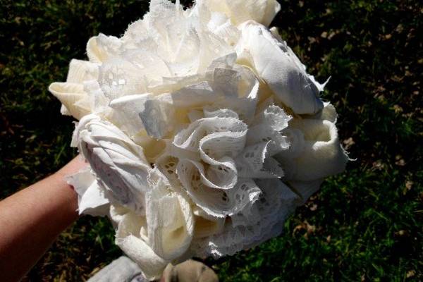 Cotton osettes, lace carnations, and cotton hydrangeas make this bouquet really speak of charm and romance.