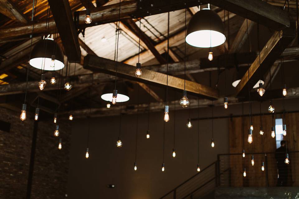 Beam Chandelier at The Roundhouse in Beacon, NY. Photo by Pat Furey, Florals by Dark & Diamond Floral Design.