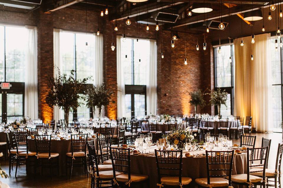 Beam Chandelier at The Roundhouse in Beacon, NY. Photo by Pat Furey, Florals by Dark & Diamond Floral Design.