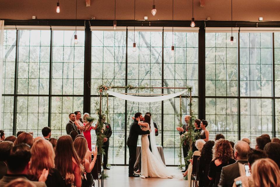 We constructed this Metal Chuppah in partnership with Viridescent Floral Design, shown here with our Beam Chandelier. Photo by The Ramsdens.
