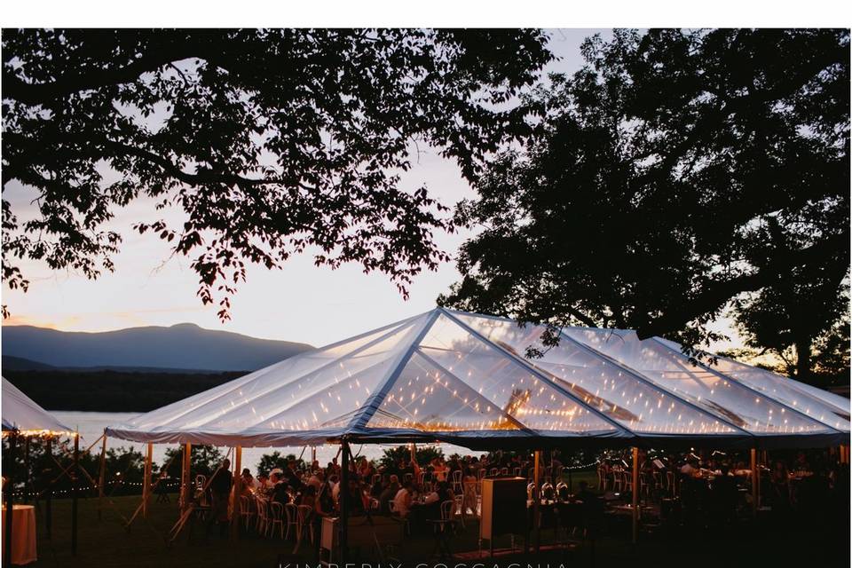 Bistro Lights & Metal Ring Chandelier in a clear-top tent. Photo by Kimberly Coccagnia.