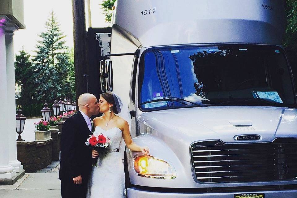 Couple kiss by the limo