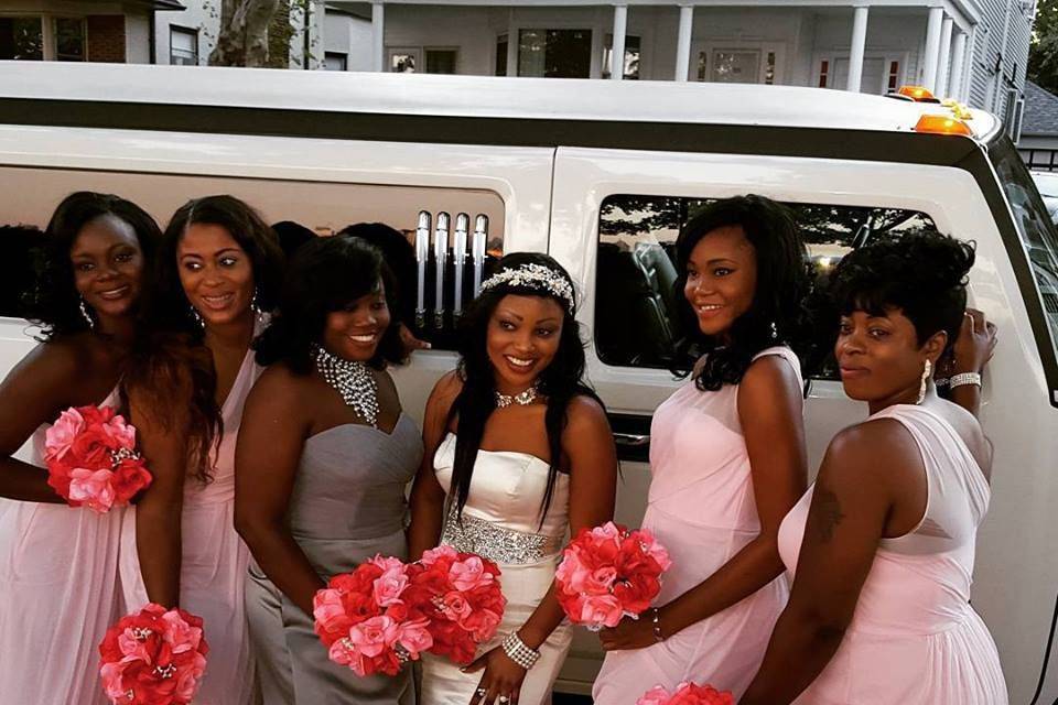 Bridesmaids by the limo