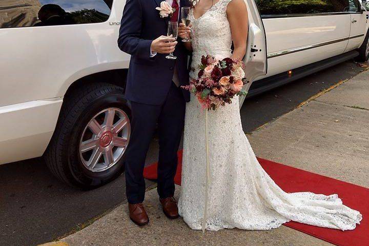 Newlyweds by the limo