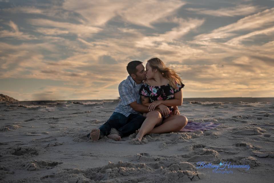 Sunset kiss of engaged couple by brittany harmening photography in mantaloking, nj