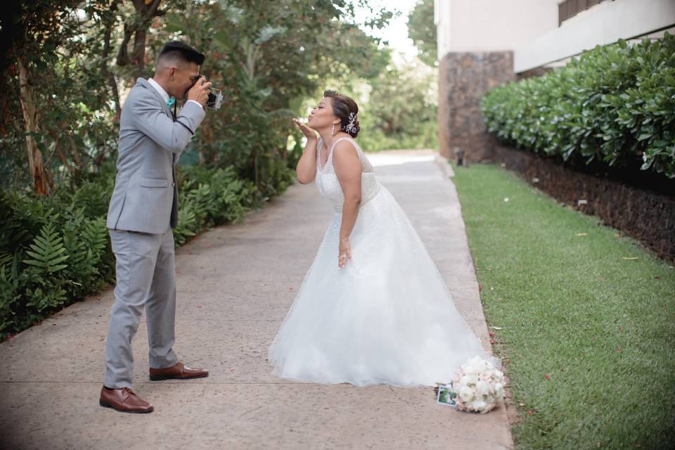 The groom taking photo of the bride