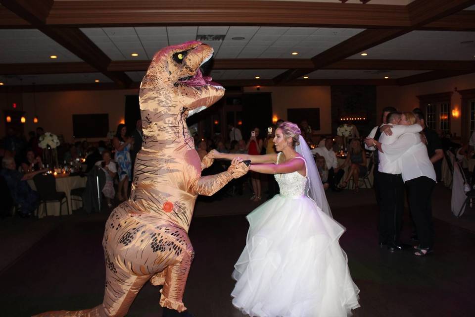 Bride dance with the dinosaur mascot