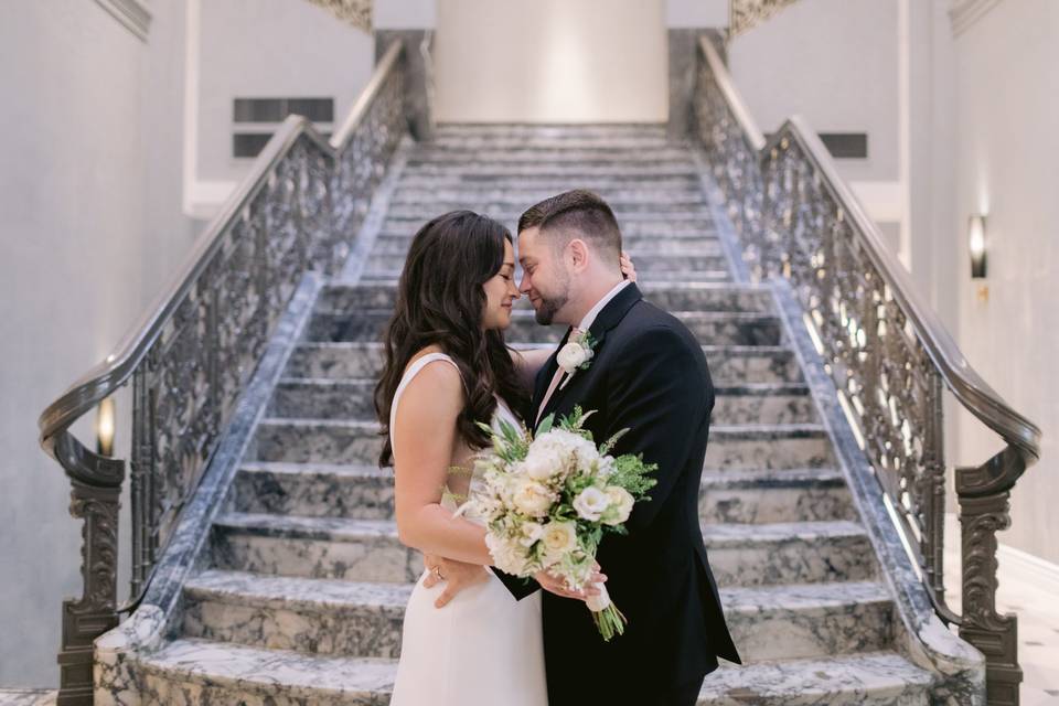 Couple in front of staircase