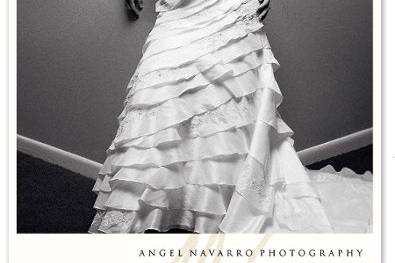 An elegant bridal portrait amidst large beige columns, in her wedding dress.