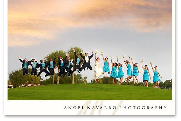 The entire bridal party jumps in the air for a late afternoon portrait.