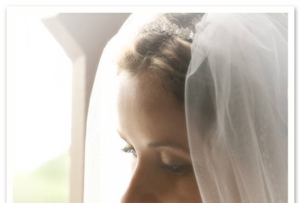 profile portrait of a bride in front of a window.
