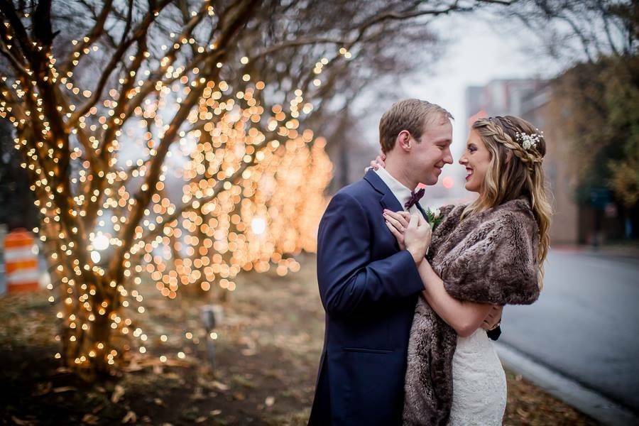 Newlyweds by the tree lights