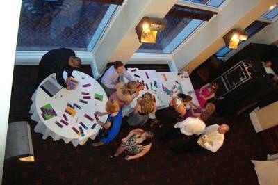 Wide shot of the Nor-Cal Photo booth to the right and all the guests adding their pictures to the scrapbook for the Bride and Groom.