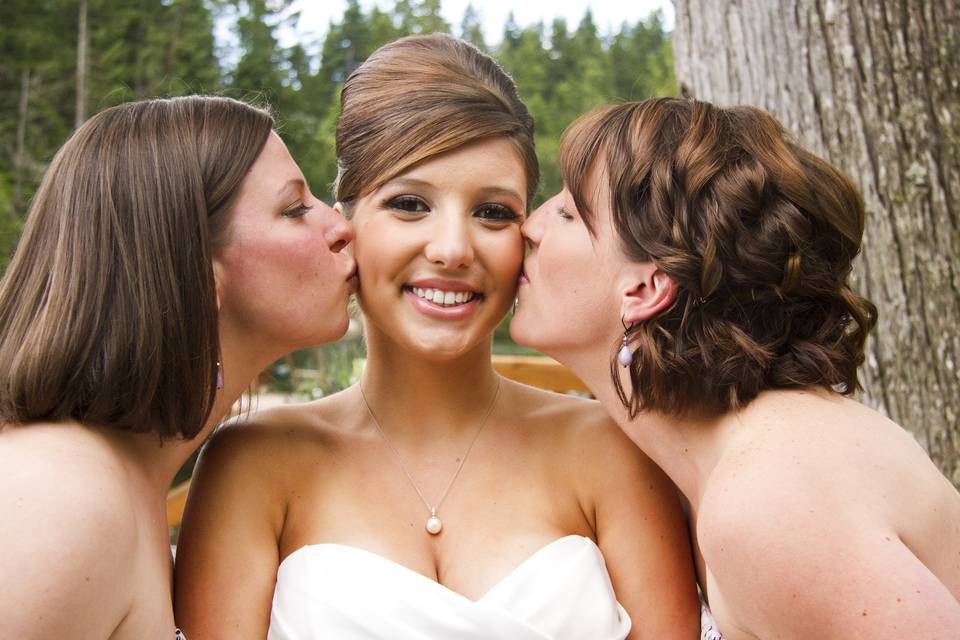 Bridesmaids kiss the bride