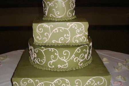 Green wedding cake with white piping