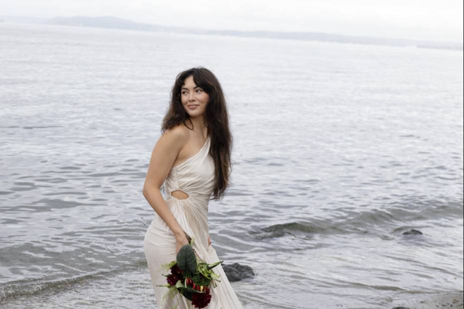 Bride posing by water