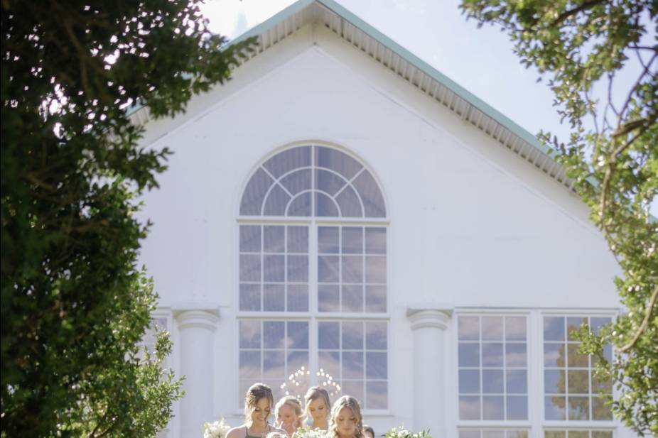 Bridesmaids helping bride