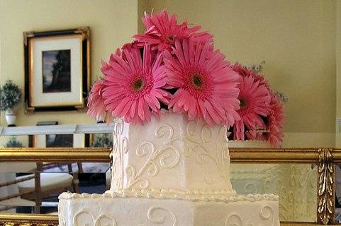 Wedding cake with pink flowers on top
