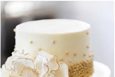 White wedding cake with gold bits