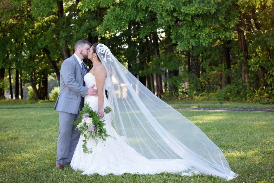 Newlyweds share a kiss | Gown: Maggie Sottero